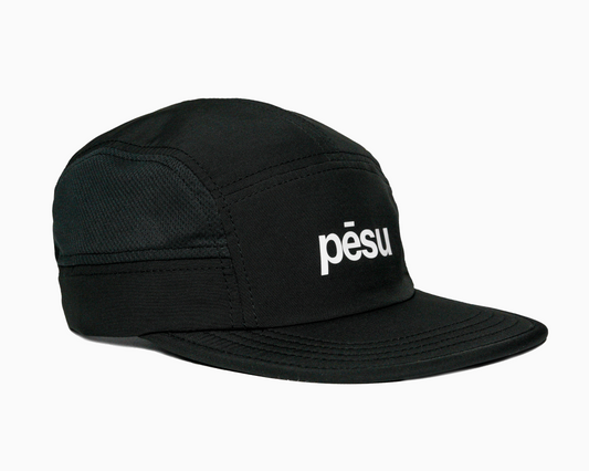Pēsu black lightweight performance 8 panel cap with breathable mesh panels, quick-dry fabric, moisture-absorbing sweatband and minimalist design for sport and lifestyle. White pēsu box logo on frontpanel.